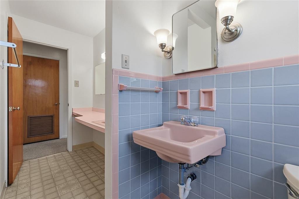 93 Stonesipher Road Oakdale, PA 15071 - Photo 20 of 36 a bathroom with a sink a light fixture and a mirror
