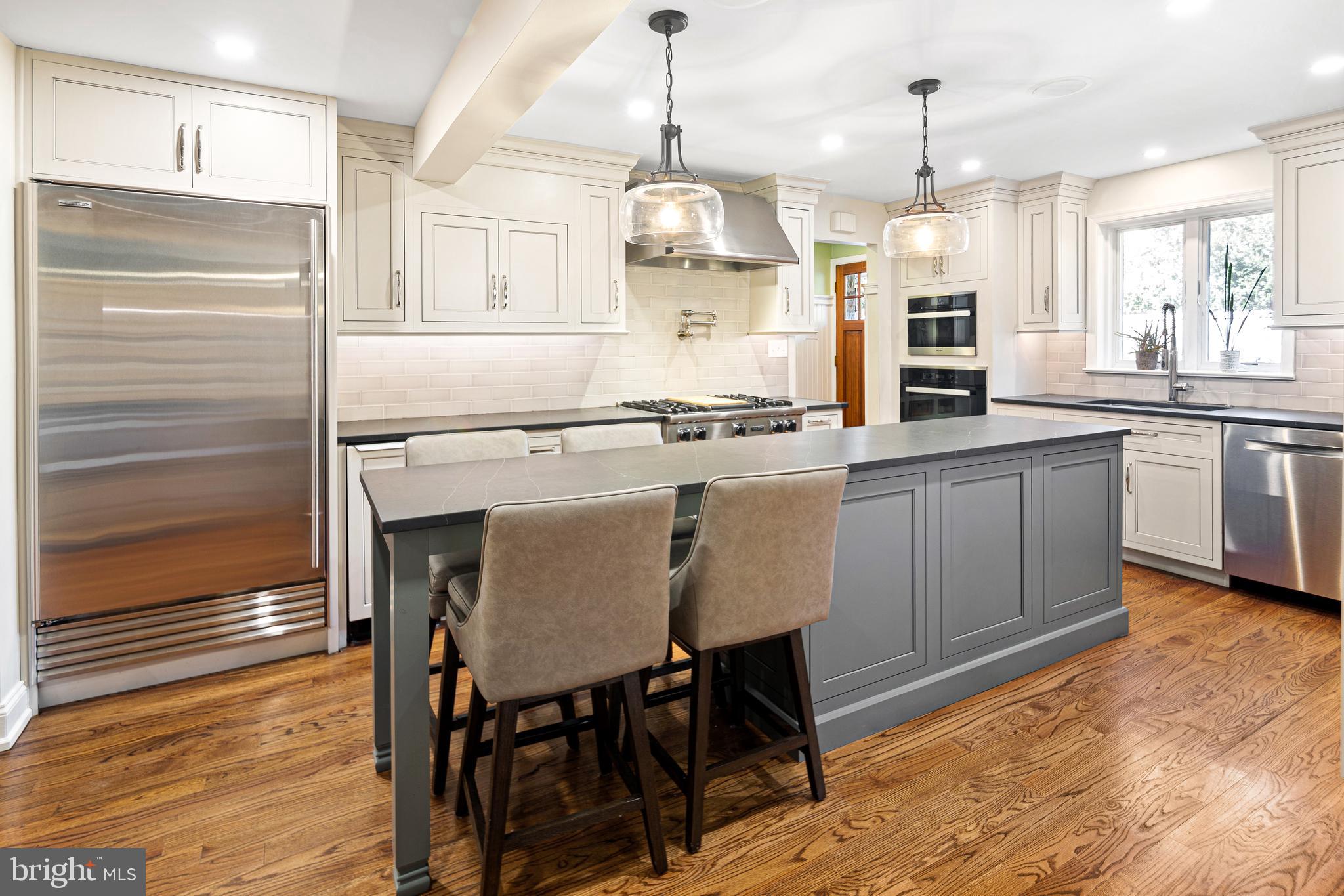 3 Briar Road Wayne, PA 19087 - Photo 11 of 48 a kitchen with kitchen island a stove a table and chairs in it