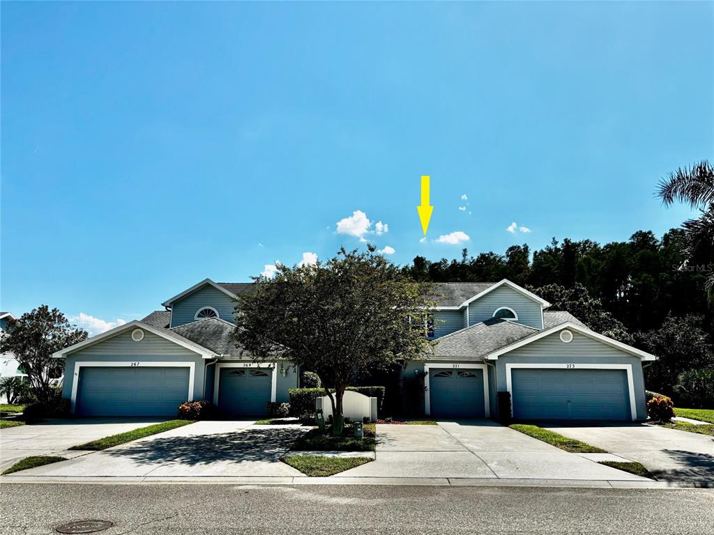 271 Hemingway Drive Oldsmar, FL 34677 - Photo 3 of 31 a front view of a house with a yard and garage