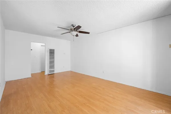 a view of a big room with a ceiling fan