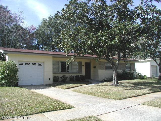 2704 Sam Road Jacksonville, FL 32216 - Photo 1 of 9 a front view of a house with a yard and garage