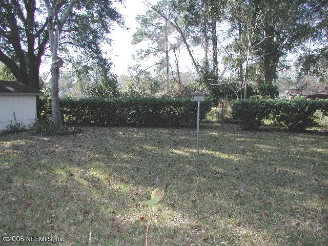 2704 Sam Road Jacksonville, FL 32216 - Photo 2 of 9 a view of a field with trees in the background