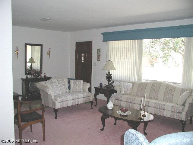 2704 Sam Road Jacksonville, FL 32216 - Photo 3 of 9 a living room with furniture and a large window