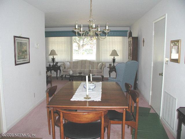 2704 Sam Road Jacksonville, FL 32216 - Photo 4 of 9 a view of a dining room with furniture and chandelier