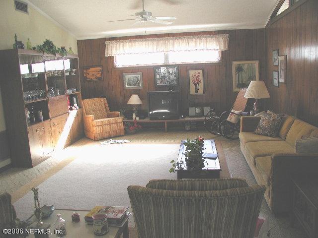 2704 Sam Road Jacksonville, FL 32216 - Photo 9 of 9 a living room with furniture and a large window