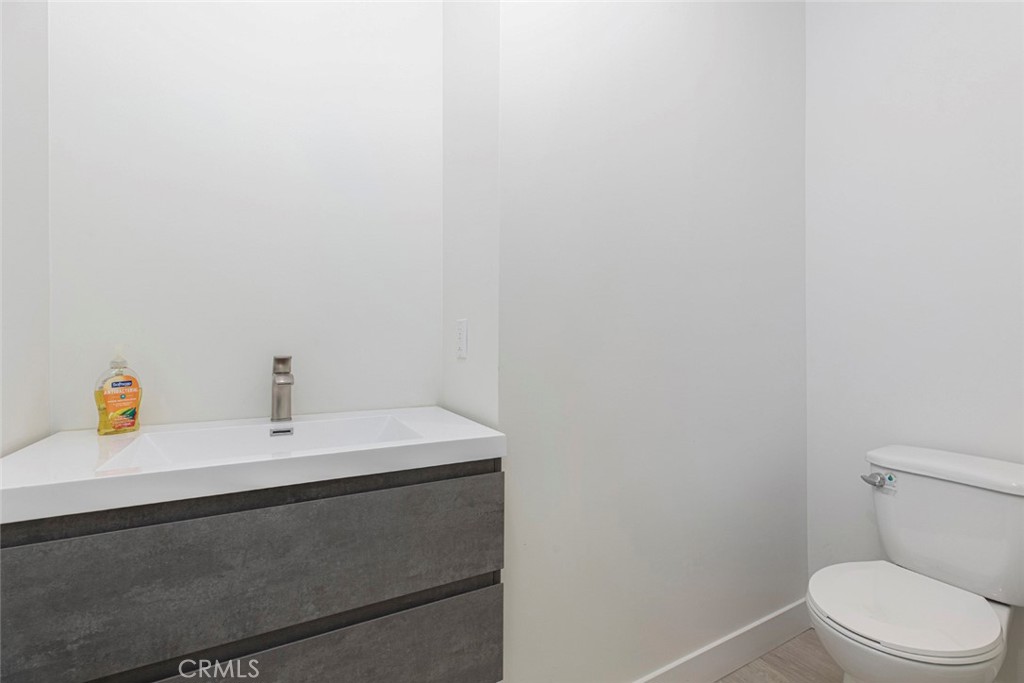 7446 Mammoth Avenue Van Nuys, CA 91405 - Photo 15 of 30 a bathroom with a sink a toilet and a mirror