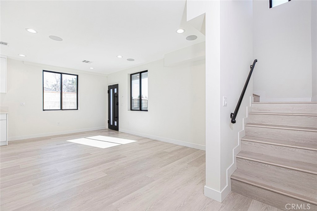 7446 Mammoth Avenue Van Nuys, CA 91405 - Photo 16 of 30 a view of an empty room with wooden floor and a window