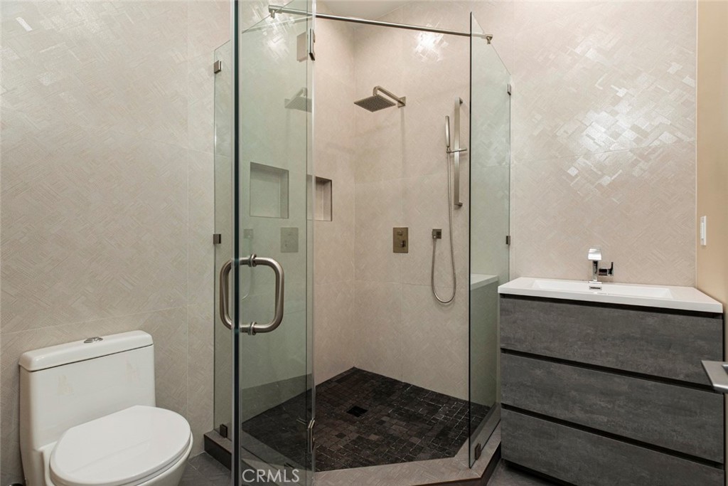 7446 Mammoth Avenue Van Nuys, CA 91405 - Photo 22 of 30 a bathroom with a sink a toilet and shower