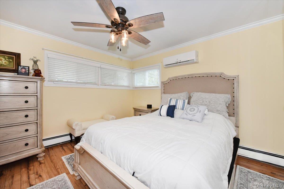 307 Blacksmith Road Levittown, NY 11756 - Photo 16 of 27 a bedroom with a bed and a chandelier