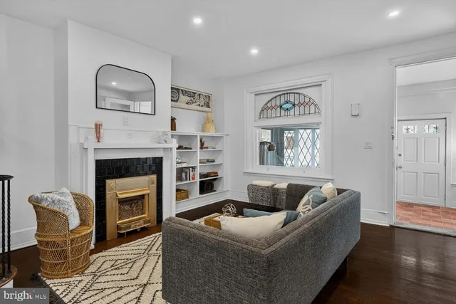 a living room with furniture and a fireplace