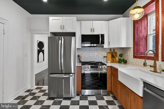 a kitchen with a refrigerator stove and cabinets