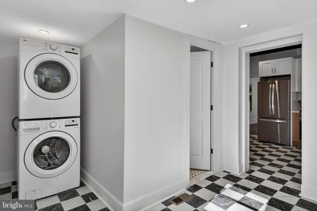 a bedroom with a large bed and a potted plant