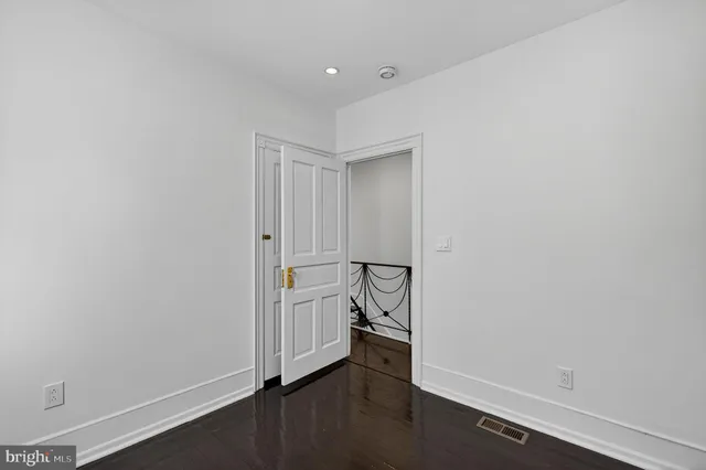an empty room with a hallway and stairs