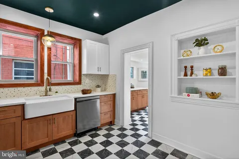 a kitchen with stainless steel appliances granite countertop a sink and a refrigerator