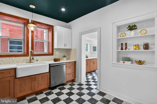 a kitchen with stainless steel appliances granite countertop a sink and a refrigerator