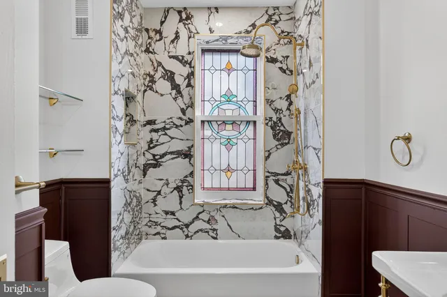 a bathroom with a bathtub and shower