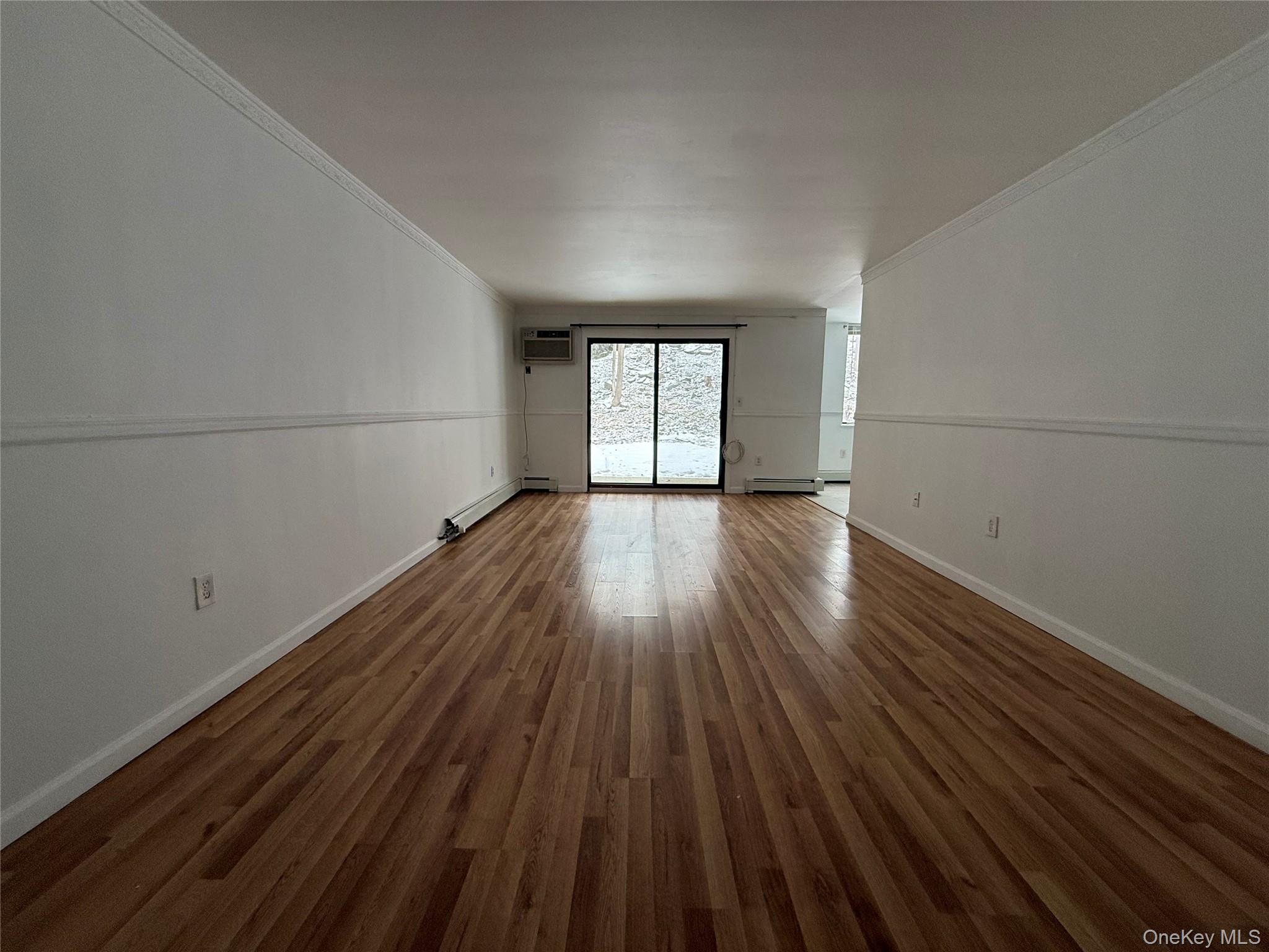 3 Hook Road, Unit 33B Poughkeepsie, NY 12601 - Photo 2 of 9 wooden floor in an empty room with a window