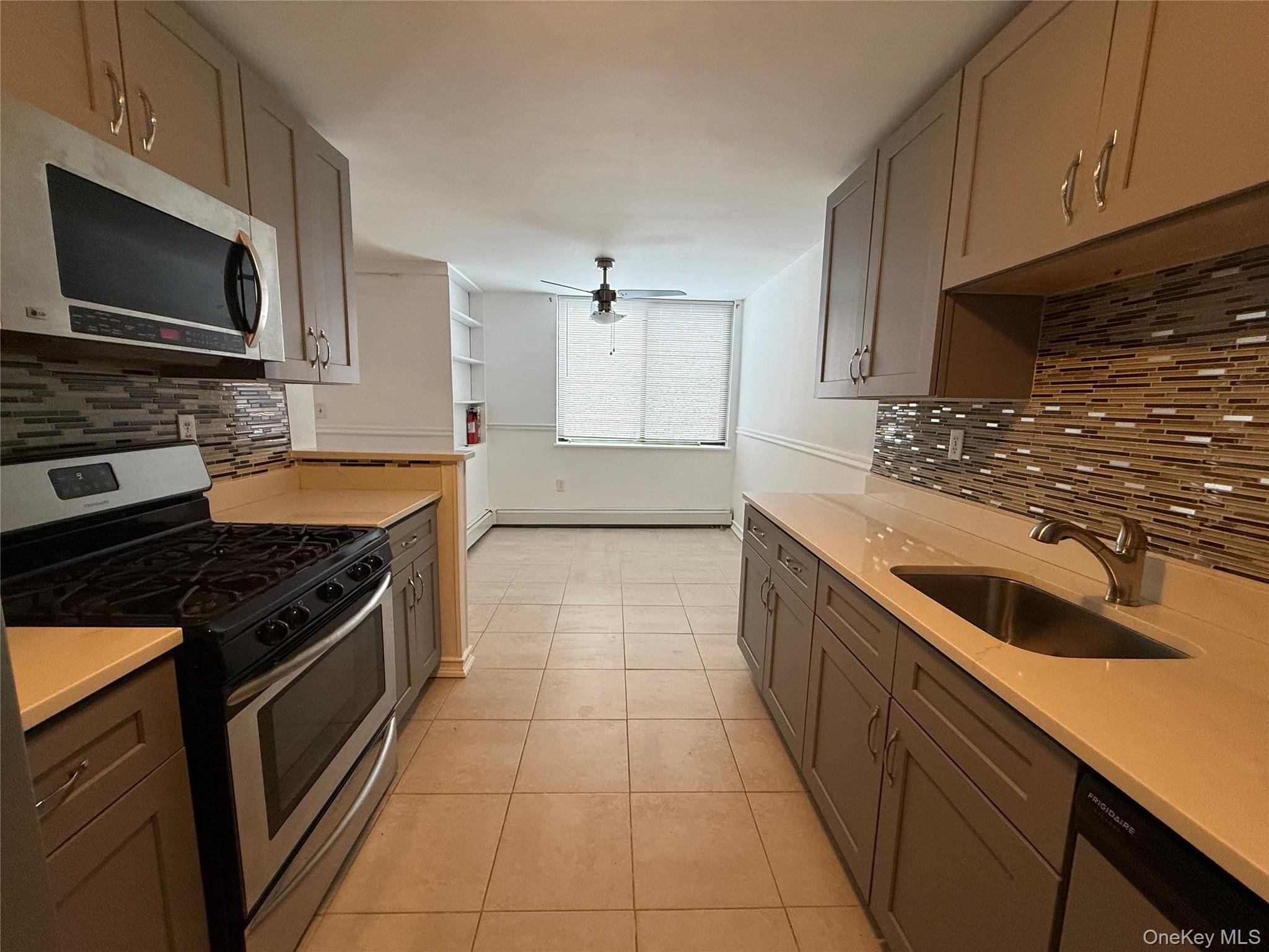 3 Hook Road, Unit 33B Poughkeepsie, NY 12601 - Photo 4 of 9 a kitchen with a stove and a microwave