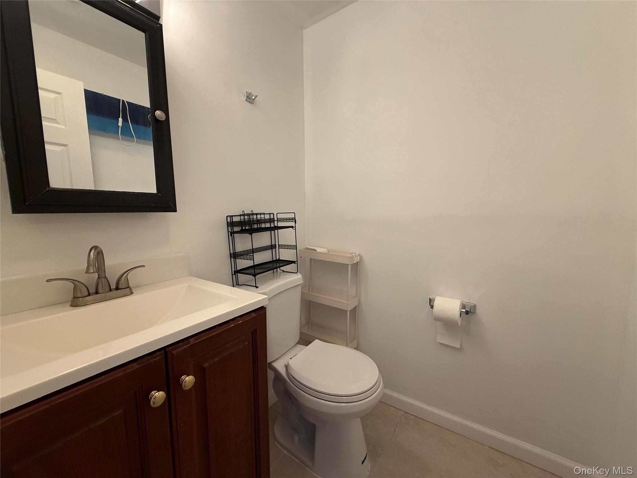 3 Hook Road, Unit 33B Poughkeepsie, NY 12601 - Photo 7 of 9 a bathroom with a sink vanity mirror and toilet