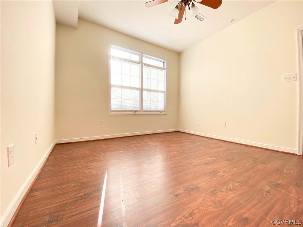 3907 Redbud Road Glen Allen, VA 23060 - Photo 11 of 23 an empty room with wooden floor fan and windows