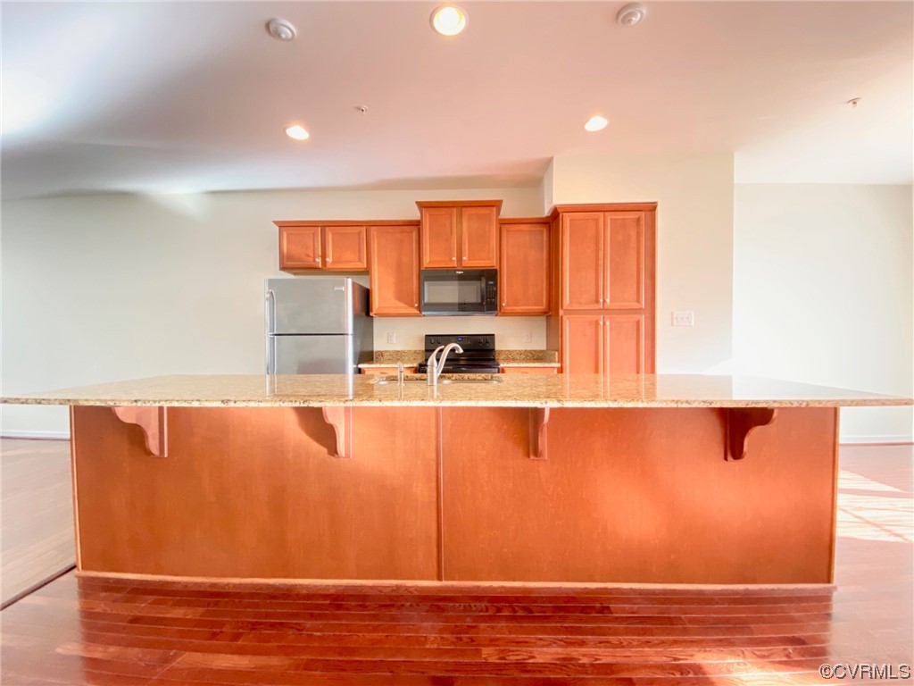 3907 Redbud Road Glen Allen, VA 23060 - Photo 3 of 23 a view of kitchen with stainless steel appliances granite countertop cabinets and a wooden floor