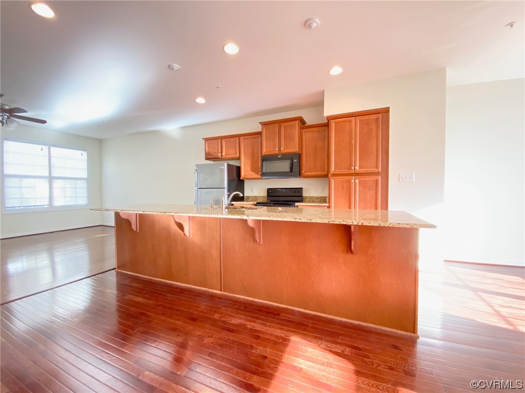 3907 Redbud Road Glen Allen, VA 23060 - Photo 4 of 23 a room with wooden floors and kitchen view