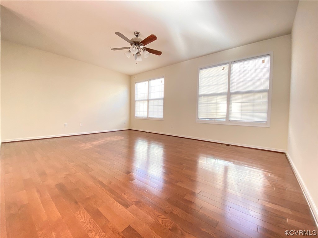 3907 Redbud Road Glen Allen, VA 23060 - Photo 8 of 23 an empty room with wooden floor fan and windows
