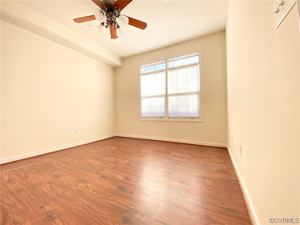 3907 Redbud Road Glen Allen, VA 23060 - Photo 10 of 23 an empty room with wooden floor fan and windows
