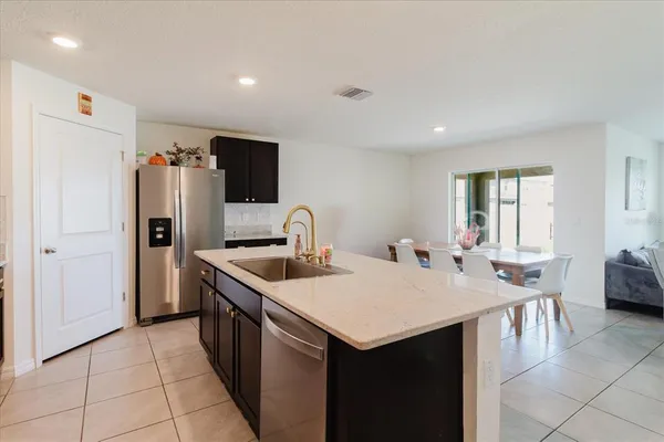 a kitchen with a cabinets and chairs