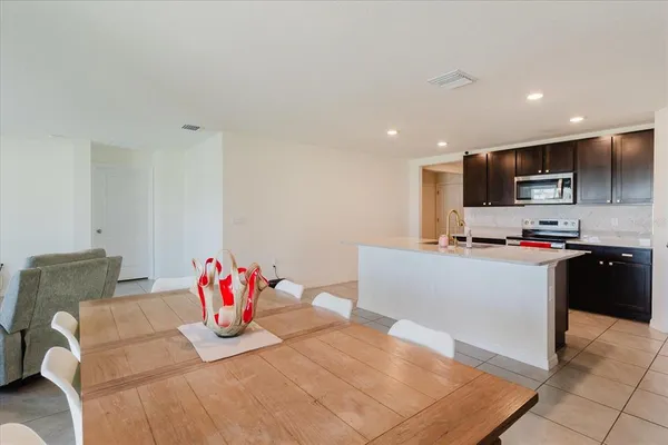 a living room with furniture and kitchen view