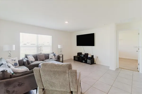 a spacious bedroom with a bed and window