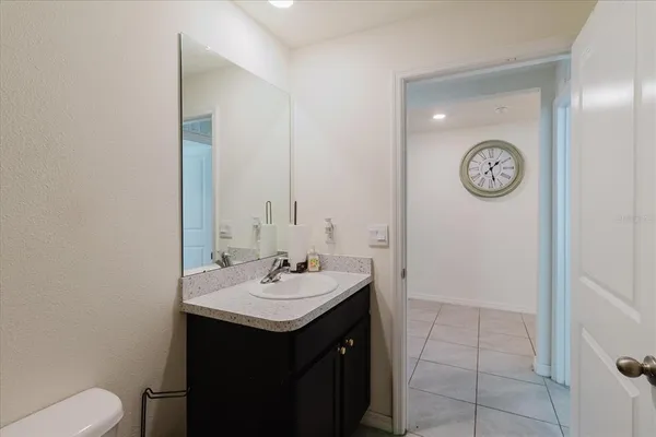 a view of a big house with a big yard and large tree