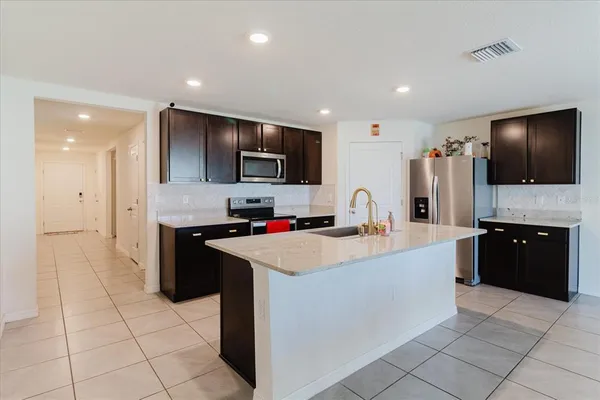 a kitchen with a sink and a refrigerator