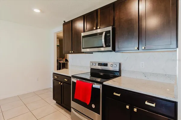a kitchen with stainless steel appliances granite countertop a stove and a microwave