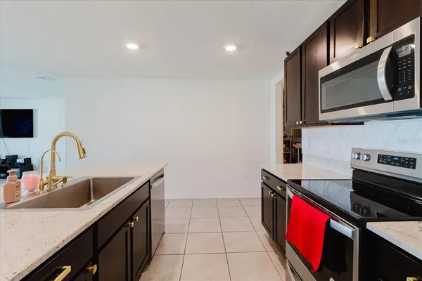a kitchen with stainless steel appliances a stove microwave and refrigerator