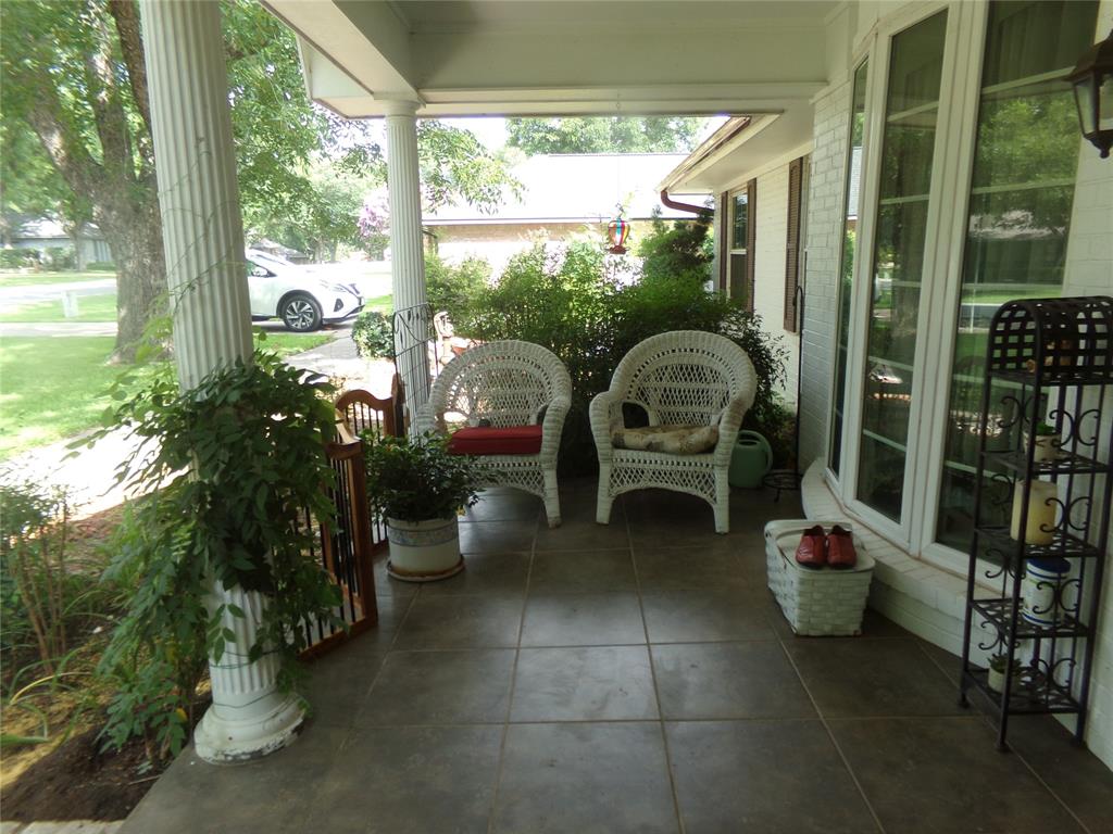 5110 Wedgefield Road Granbury, TX 76049 - Photo 4 of 23 Covered front porch featuring large square tile flooring and fluted columns