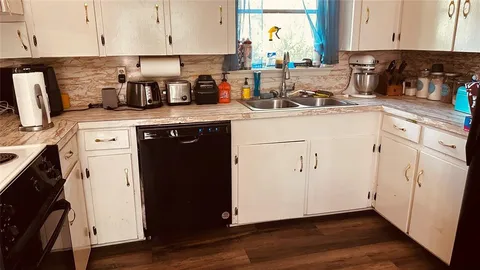 a kitchen with stainless steel appliances granite countertop a refrigerator a sink a stove a microwave and wooden cabinets