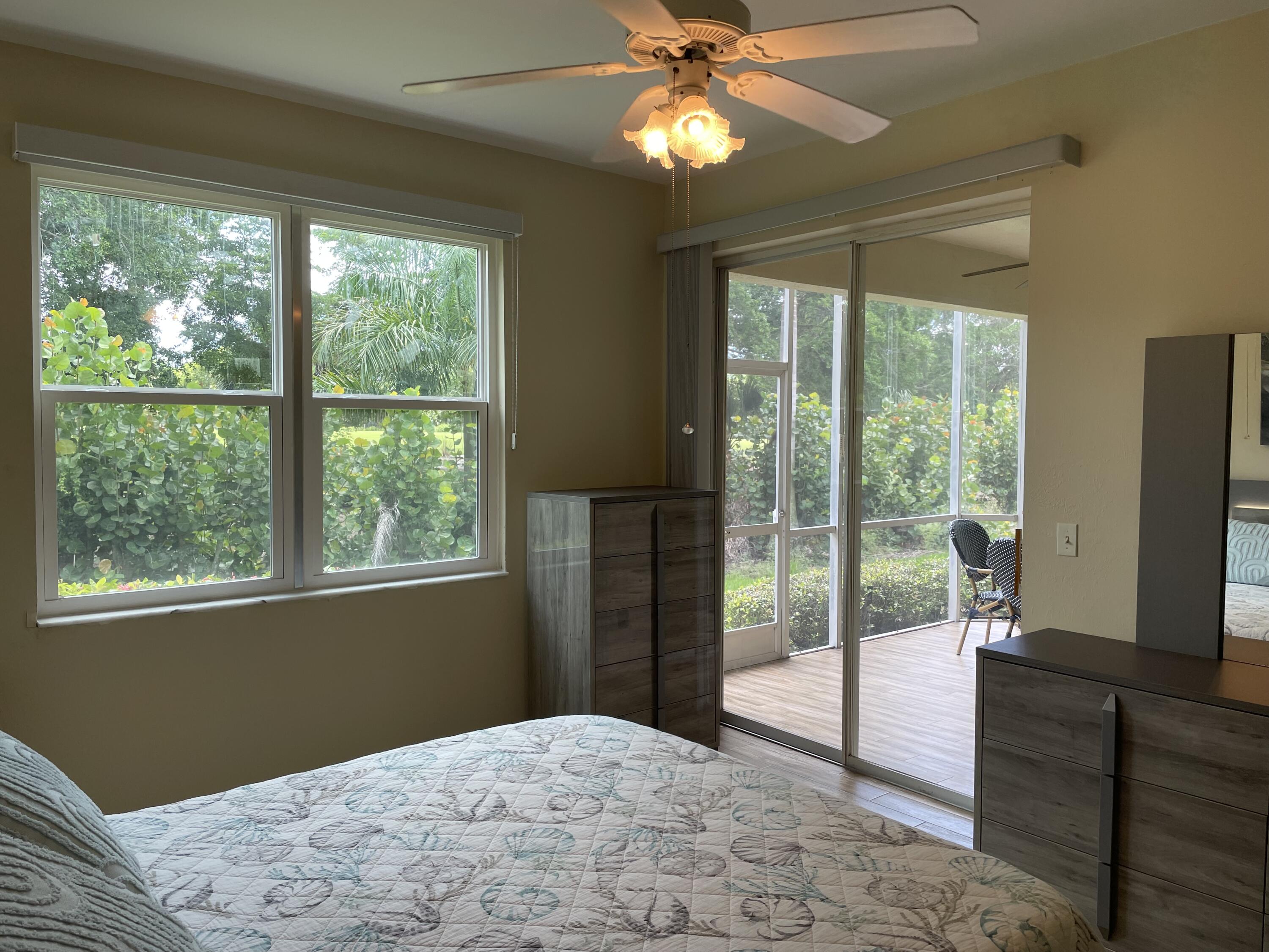 1024 Mainsail, Unit 514 Naples, FL 34114 - Photo 11 of 18 a bedroom with a bed and a large window