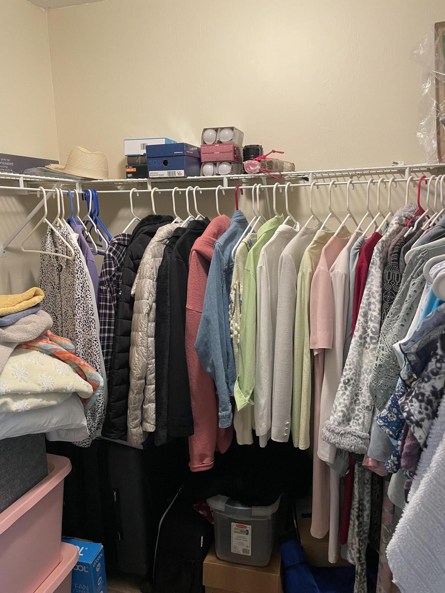 1024 Mainsail, Unit 514 Naples, FL 34114 - Photo 14 of 18 a view of walk in closet with clothes and shoes