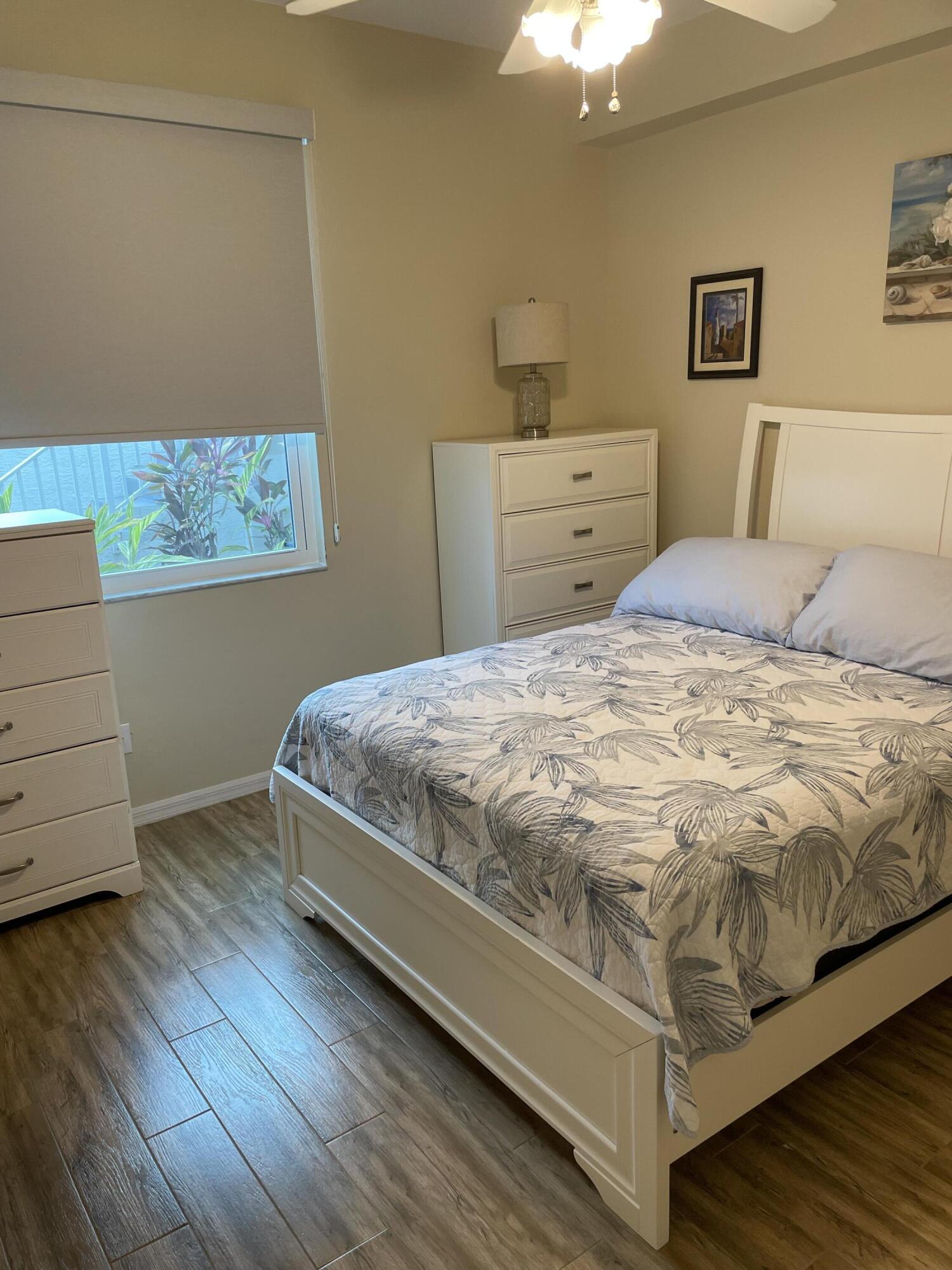 1024 Mainsail, Unit 514 Naples, FL 34114 - Photo 15 of 18 a bedroom with a bed and a dresser
