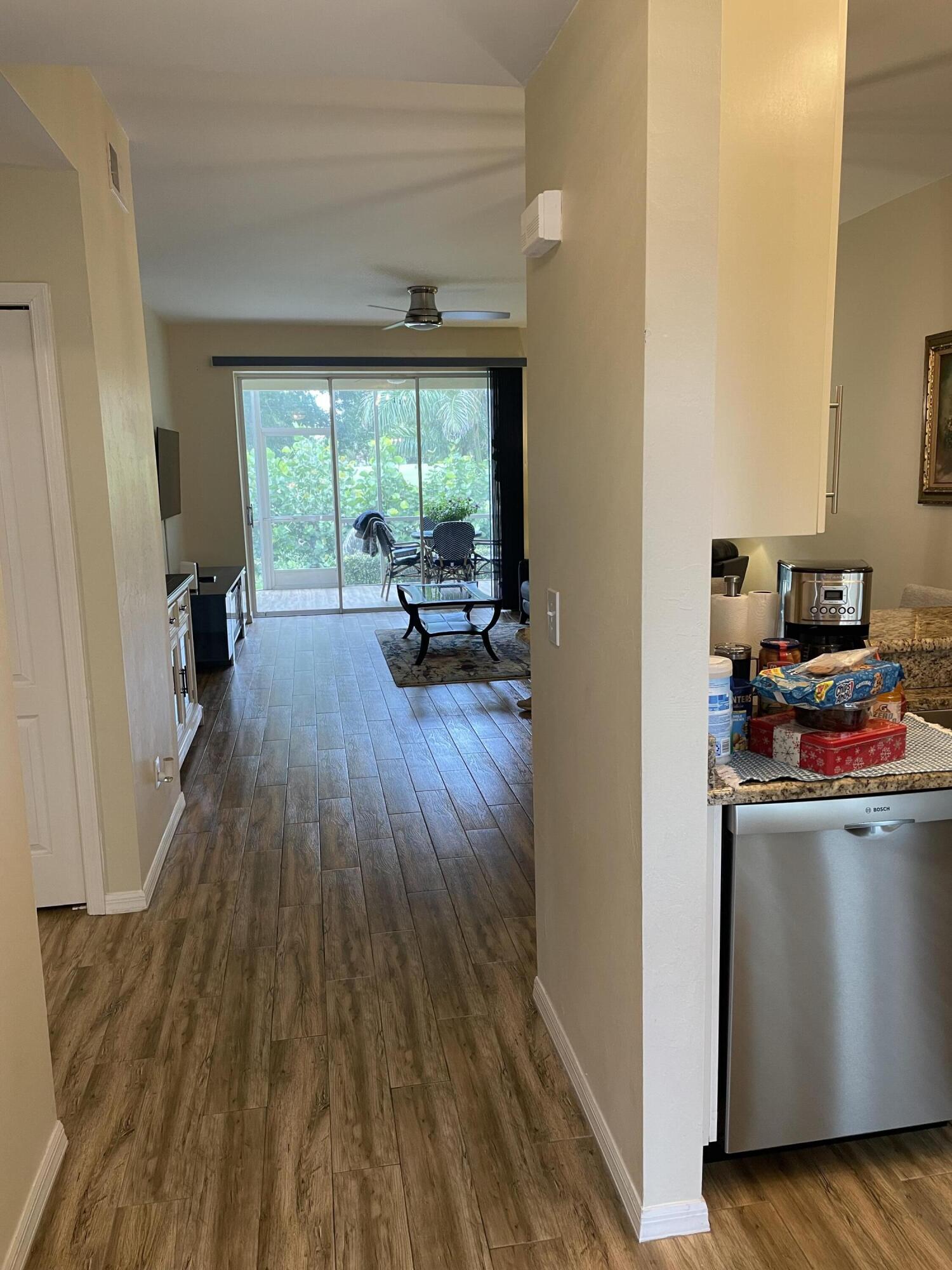 1024 Mainsail, Unit 514 Naples, FL 34114 - Photo 2 of 18 a living room with furniture and a wooden floor