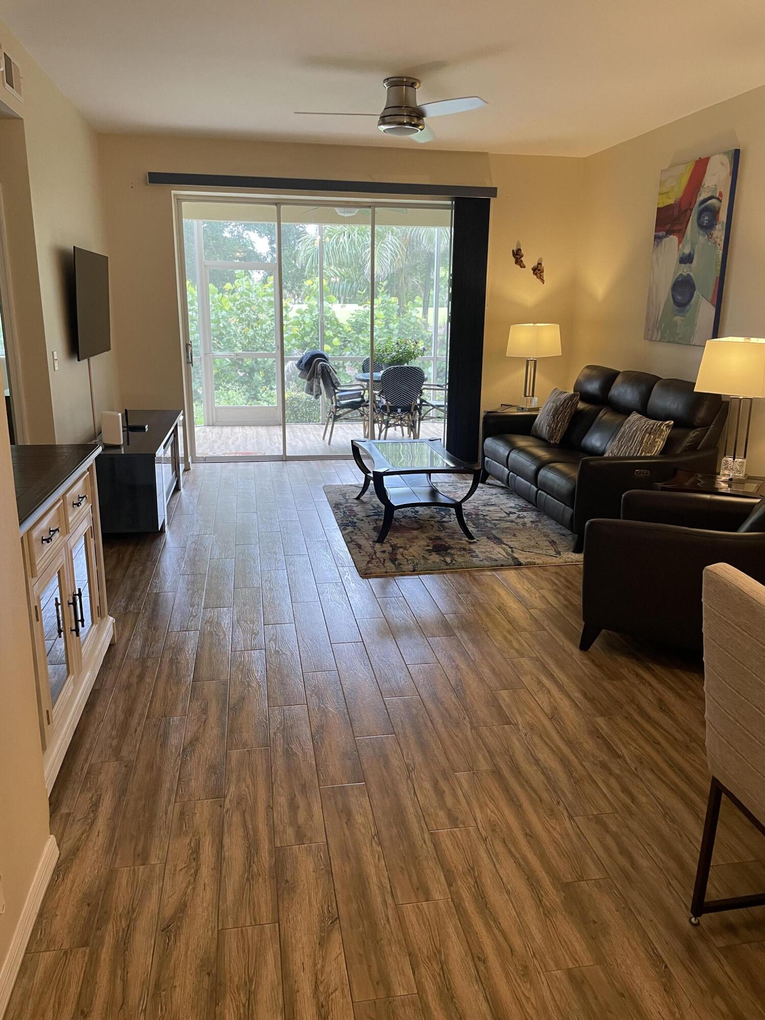 1024 Mainsail, Unit 514 Naples, FL 34114 - Photo 3 of 18 a living room with furniture and a wooden floor