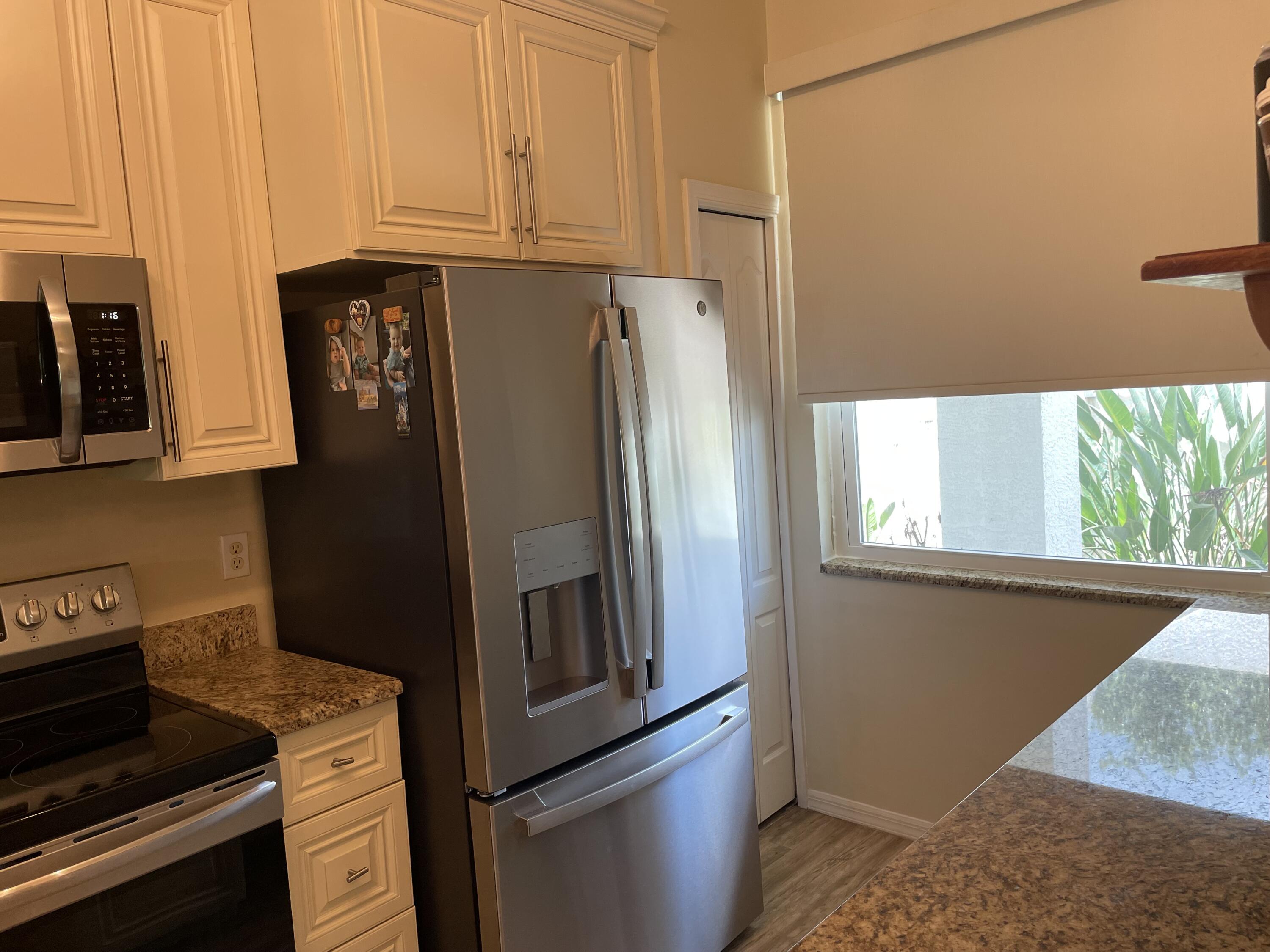 1024 Mainsail, Unit 514 Naples, FL 34114 - Photo 4 of 18 a kitchen with stainless steel appliances granite countertop a refrigerator and a stove