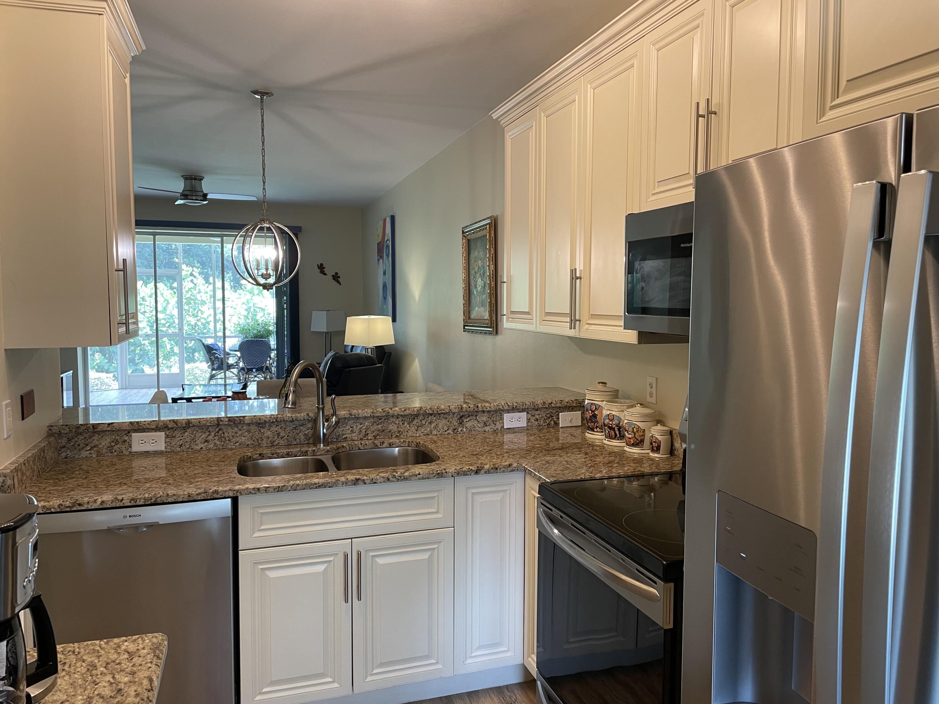 1024 Mainsail, Unit 514 Naples, FL 34114 - Photo 5 of 18 a kitchen with a sink stove and refrigerator