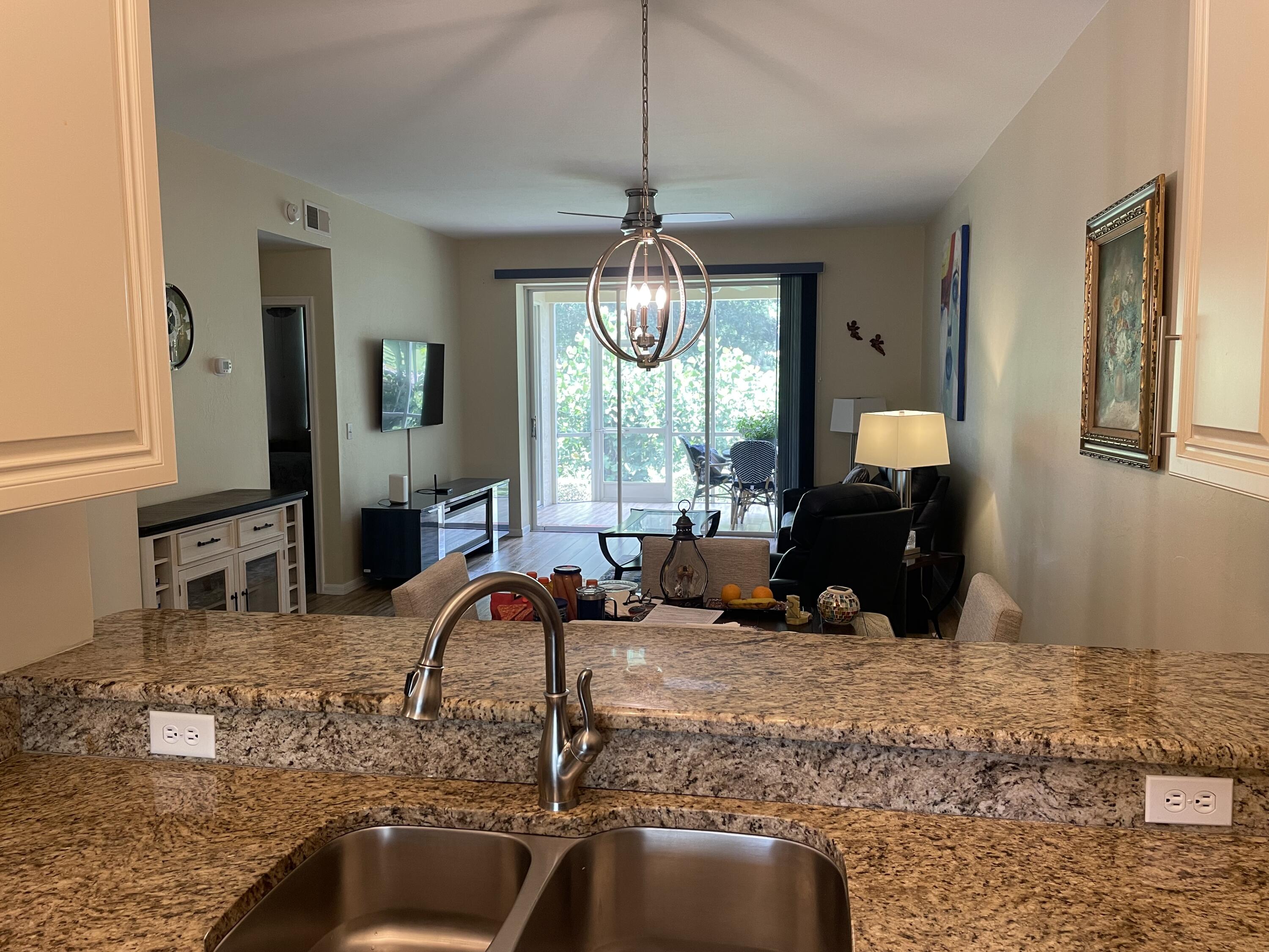 1024 Mainsail, Unit 514 Naples, FL 34114 - Photo 6 of 18 a living room filled with furniture chandelier and a chandelier