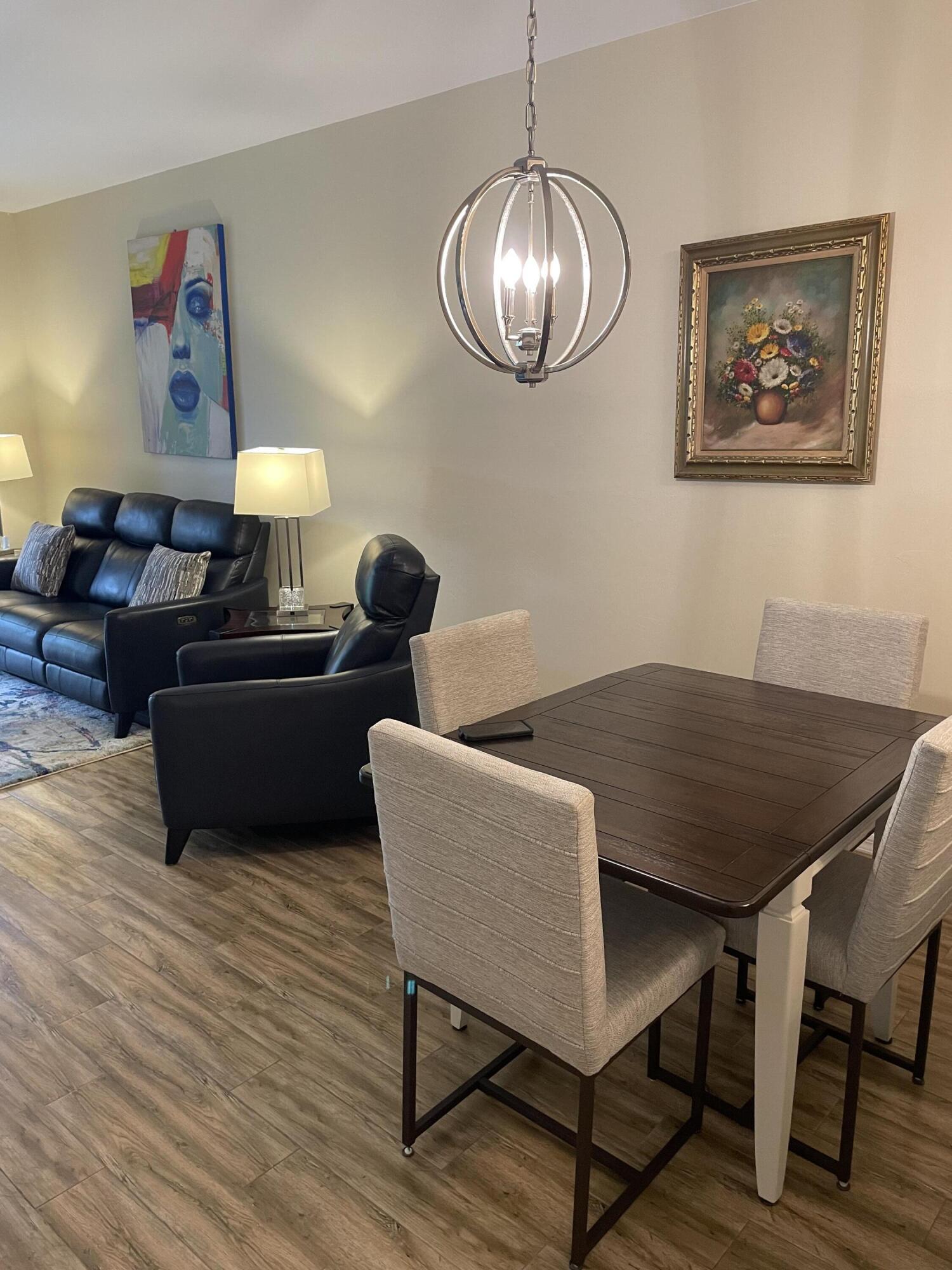 1024 Mainsail, Unit 514 Naples, FL 34114 - Photo 7 of 18 a living room with furniture a table and wooden floor