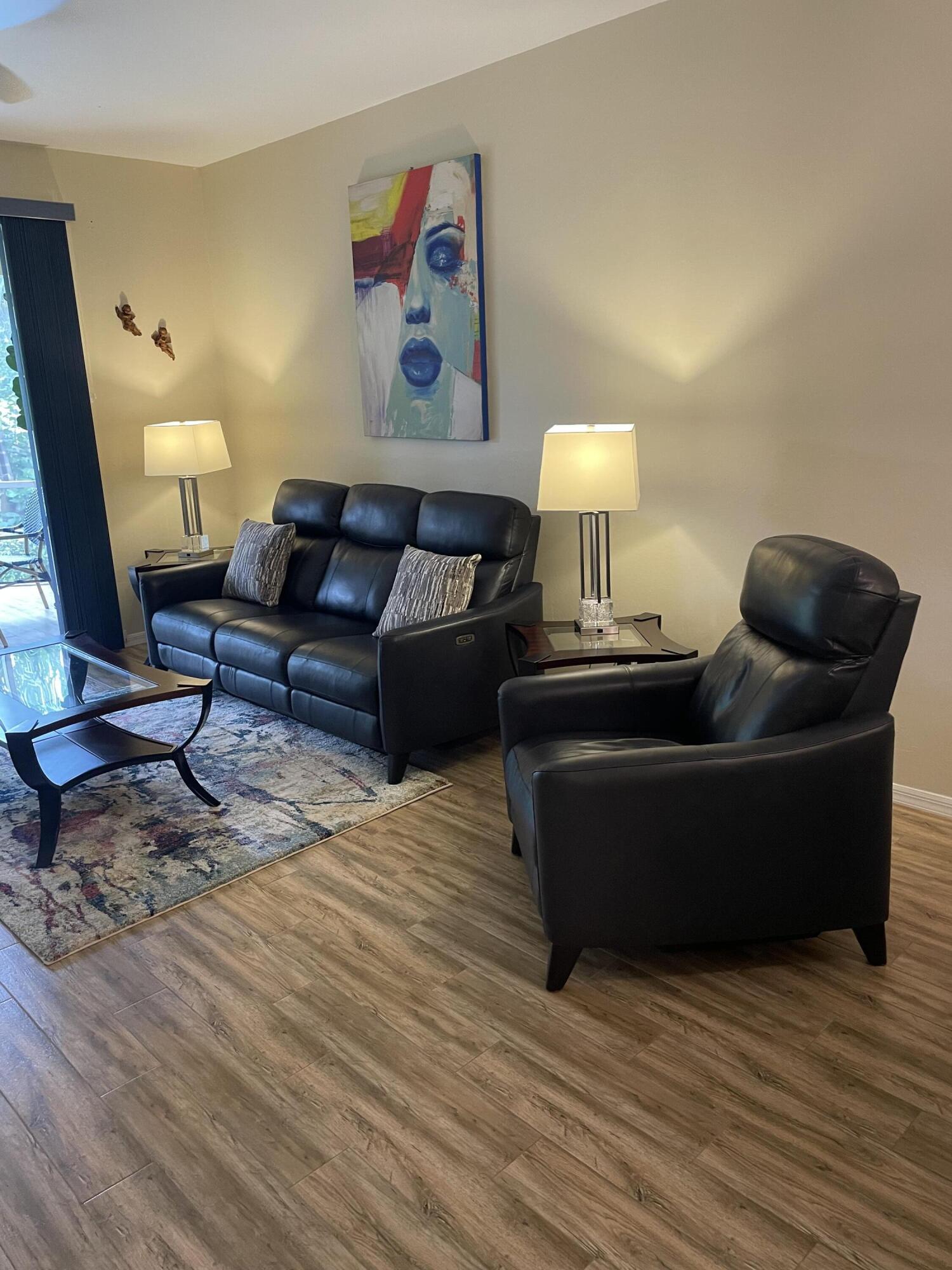 1024 Mainsail, Unit 514 Naples, FL 34114 - Photo 8 of 18 a living room with furniture and a lamp