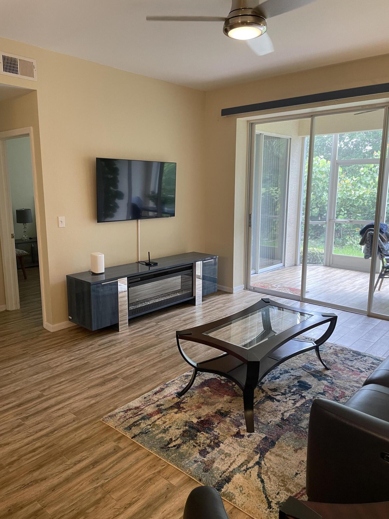 1024 Mainsail, Unit 514 Naples, FL 34114 - Photo 9 of 18 a living room with furniture and a wooden floor