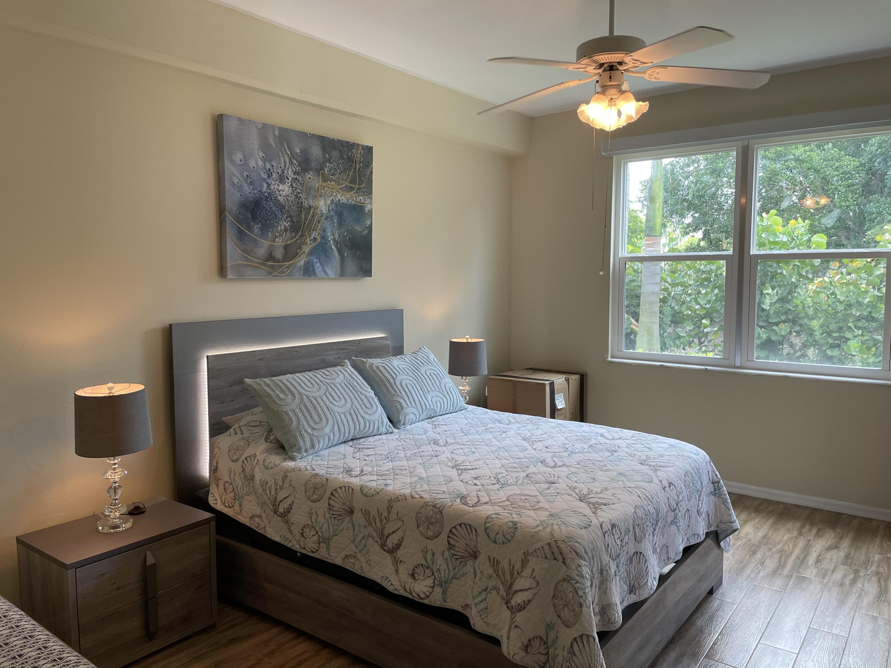 1024 Mainsail, Unit 514 Naples, FL 34114 - Photo 10 of 18 a bedroom with a bed and a window