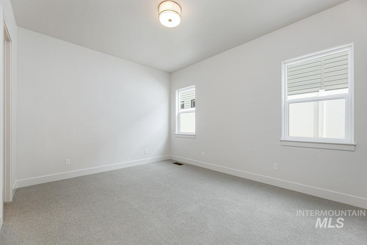 13758 North Ruffed Grouse Way Boise, ID 83714 - Photo 26 of 45 Spare room featuring light colored carpet and baseboards